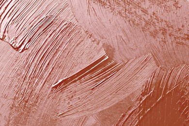 Image of Beautiful strokes of rose gold paint as background, closeup