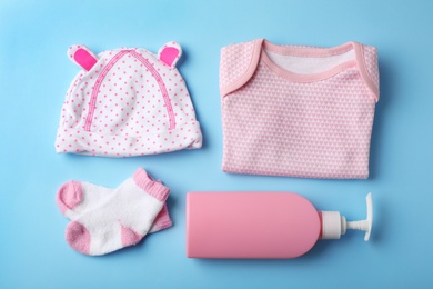 Photo of Flat lay composition with stylish baby clothes on color background