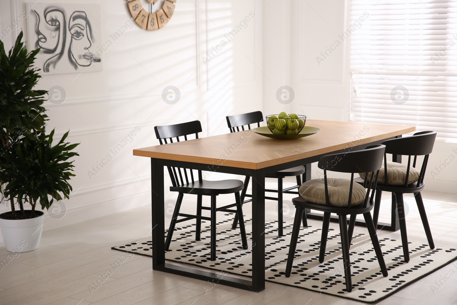 Photo of Stylish wooden dining table and chairs in room. Interior design