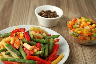 Photo of Mix of different frozen vegetables on wooden table, closeup