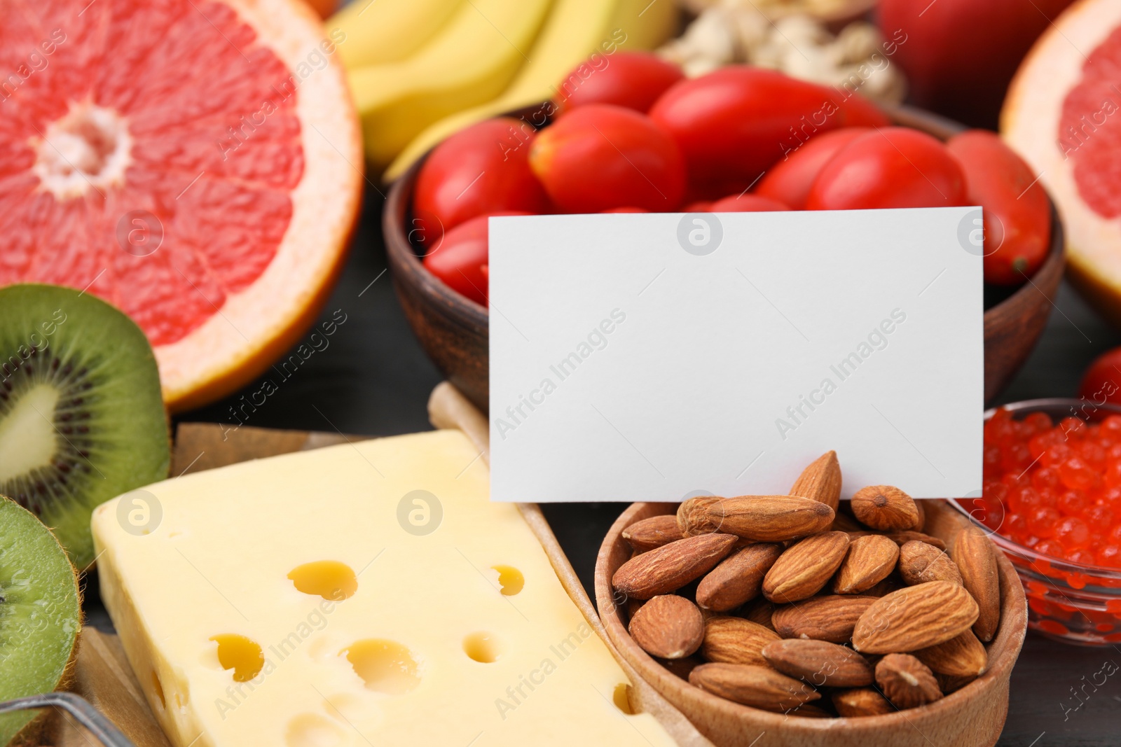 Photo of Many different products and blank card on table, closeup with space for text. Natural sources of serotonin
