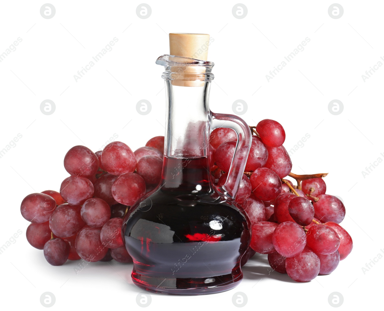 Photo of Glass jug with wine vinegar and fresh grapes on white background