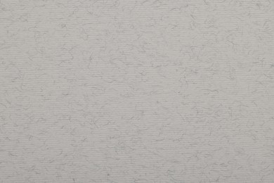 Photo of Texture of light grey paper sheet as background, top view