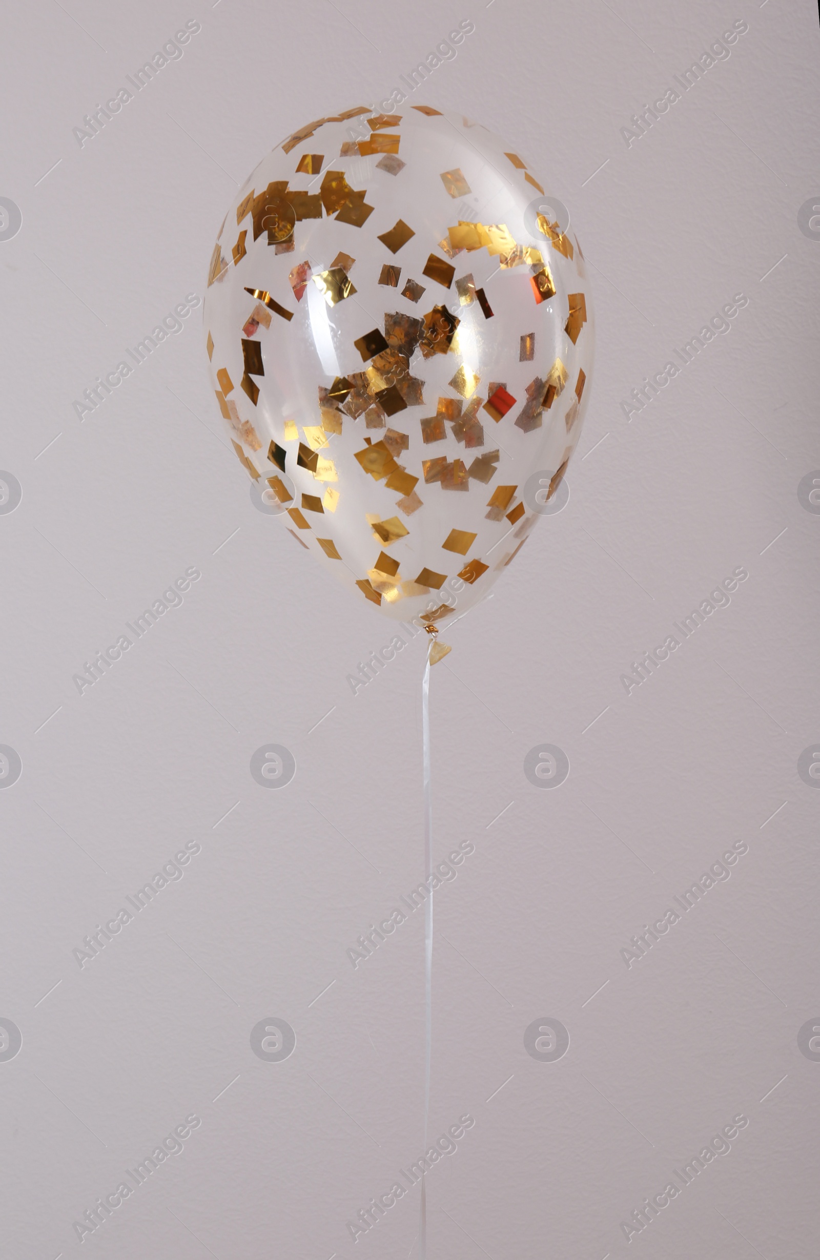 Photo of Bright balloon with sparkles on grey background