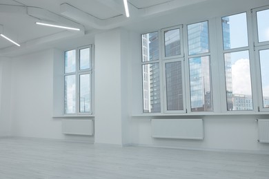 Photo of New empty room with clean windows and white wall