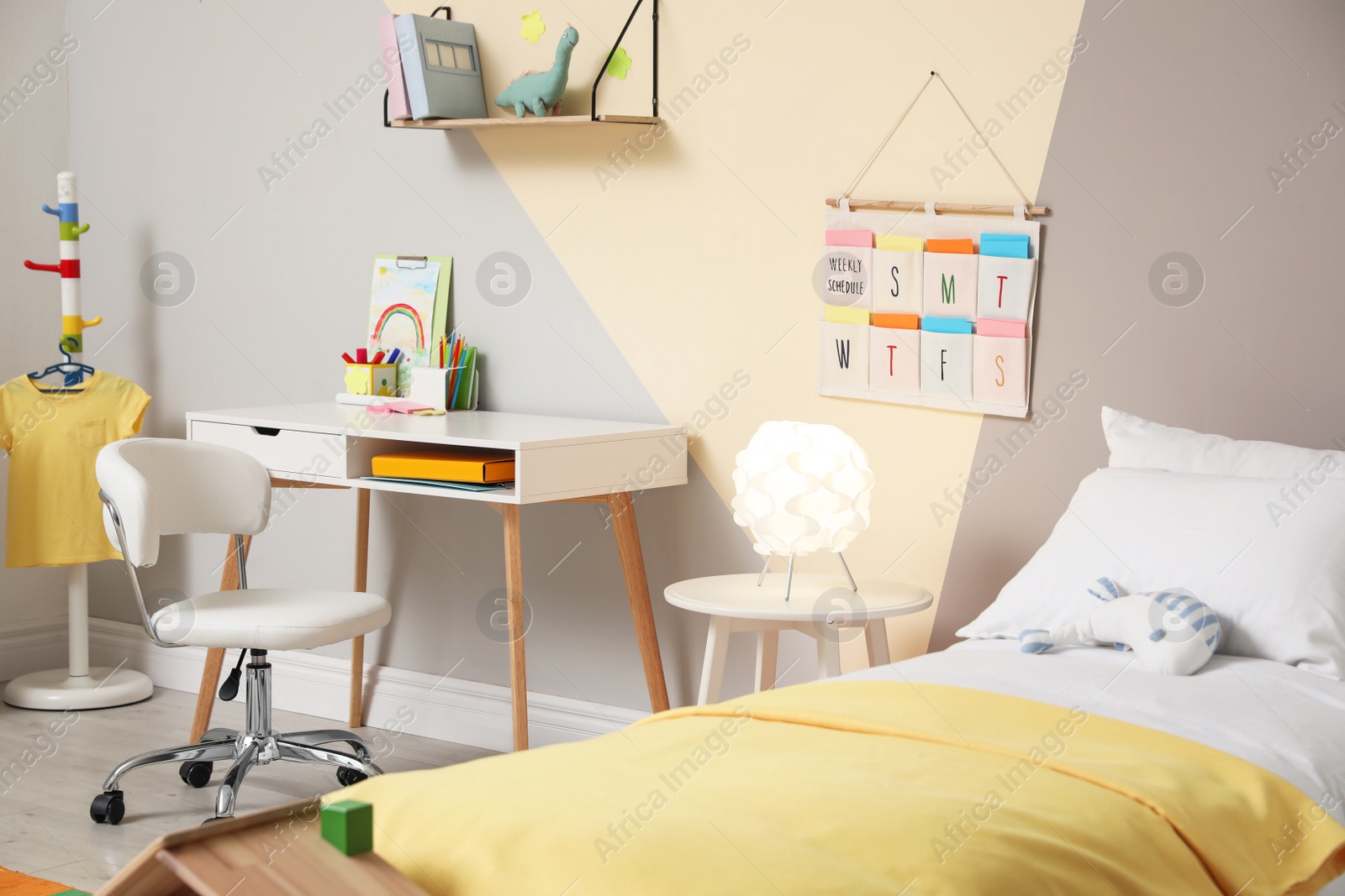 Photo of Stylish child room interior with comfortable bed and desk