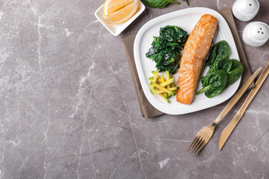 Photo of Tasty salmon with spinach and avocado served on marble table, flat lay. Space for text