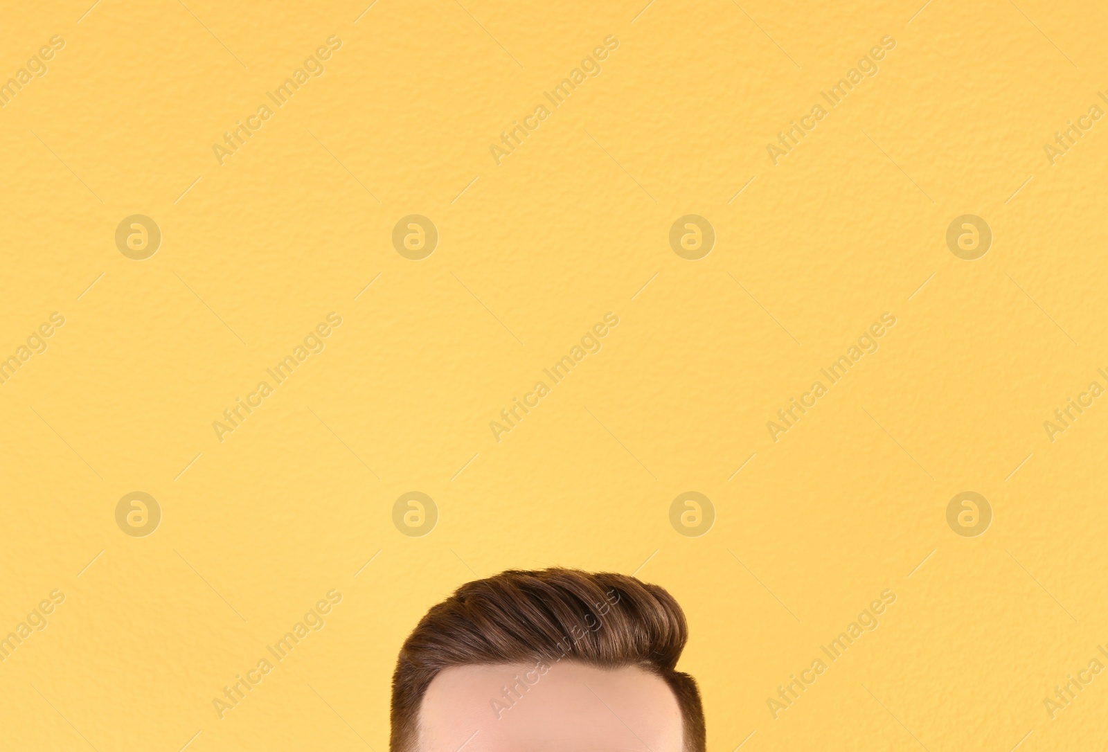 Photo of Man with beautiful hair on color background, closeup