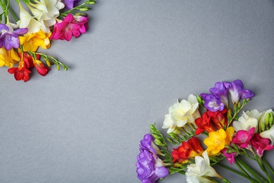 Photo of Beautiful freesia flowers on grey background