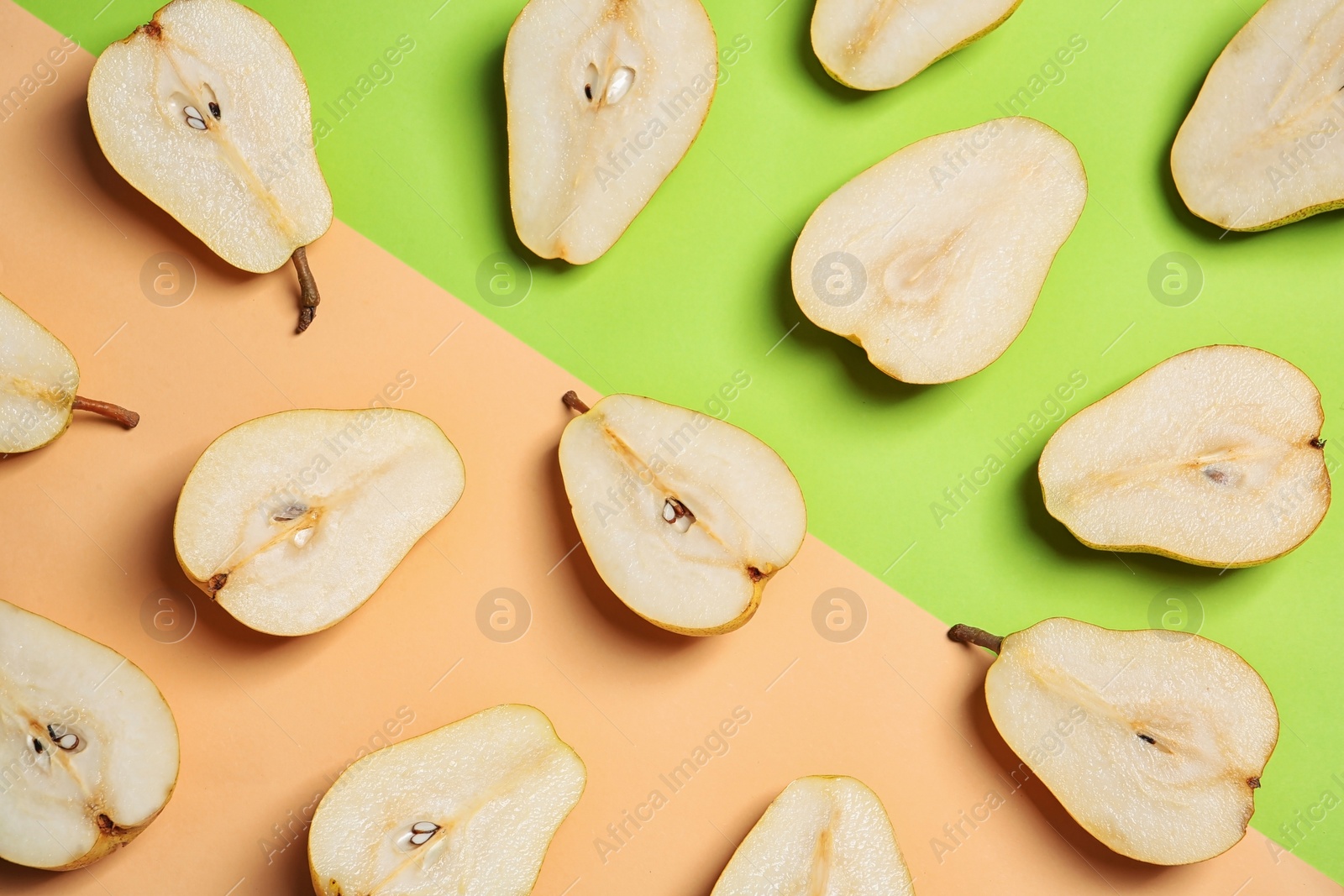 Photo of Flat lay composition with halves of fresh ripe pears on color background