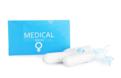 Photo of Card and hygienic tampons on white background. Gynecology concept