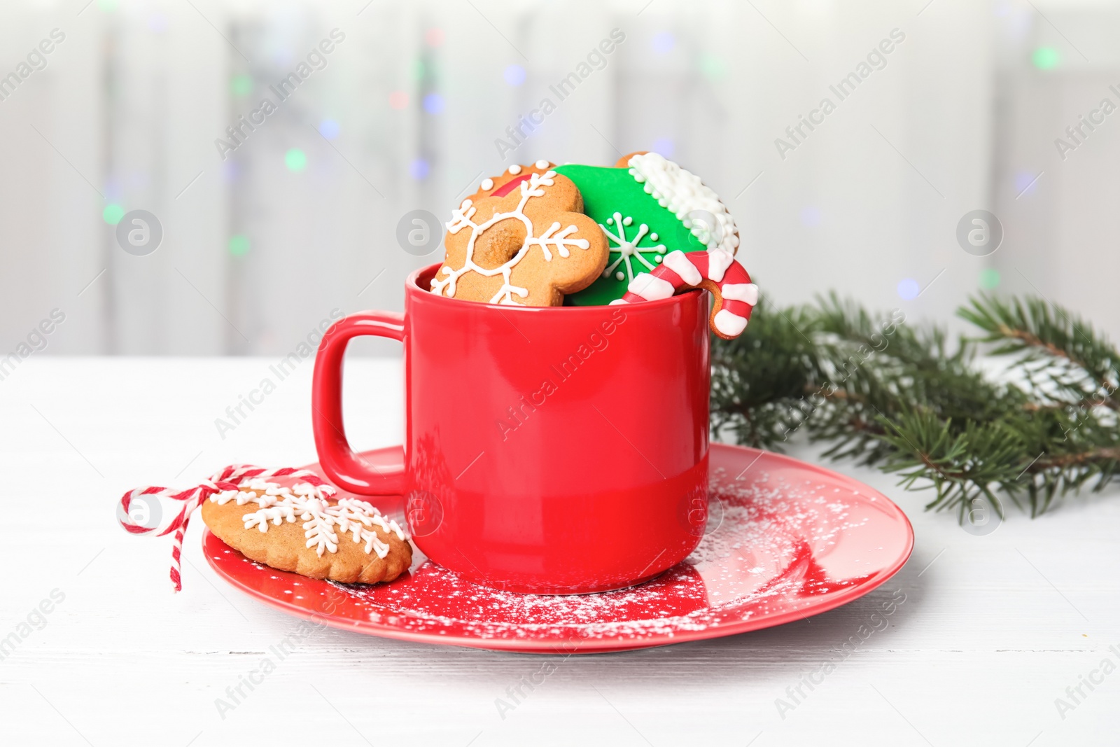 Cup with tasty homemade Christmas cookies on table Photo of Cup with tasty homemade Christmas cookies on table