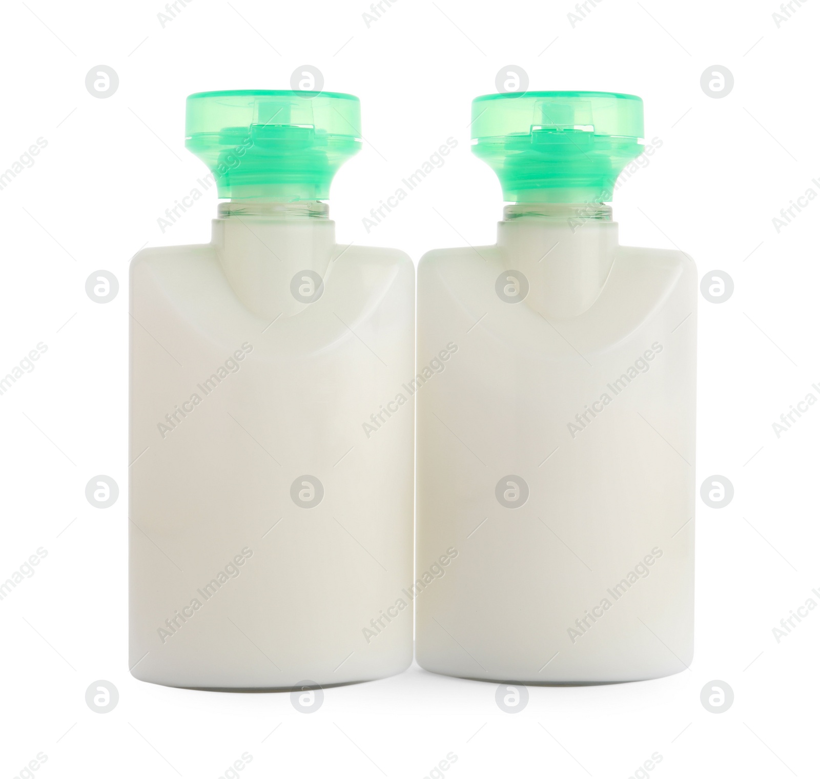 Mini bottles of cosmetic products isolated on white Photo of Mini bottles of cosmetic products isolated on white