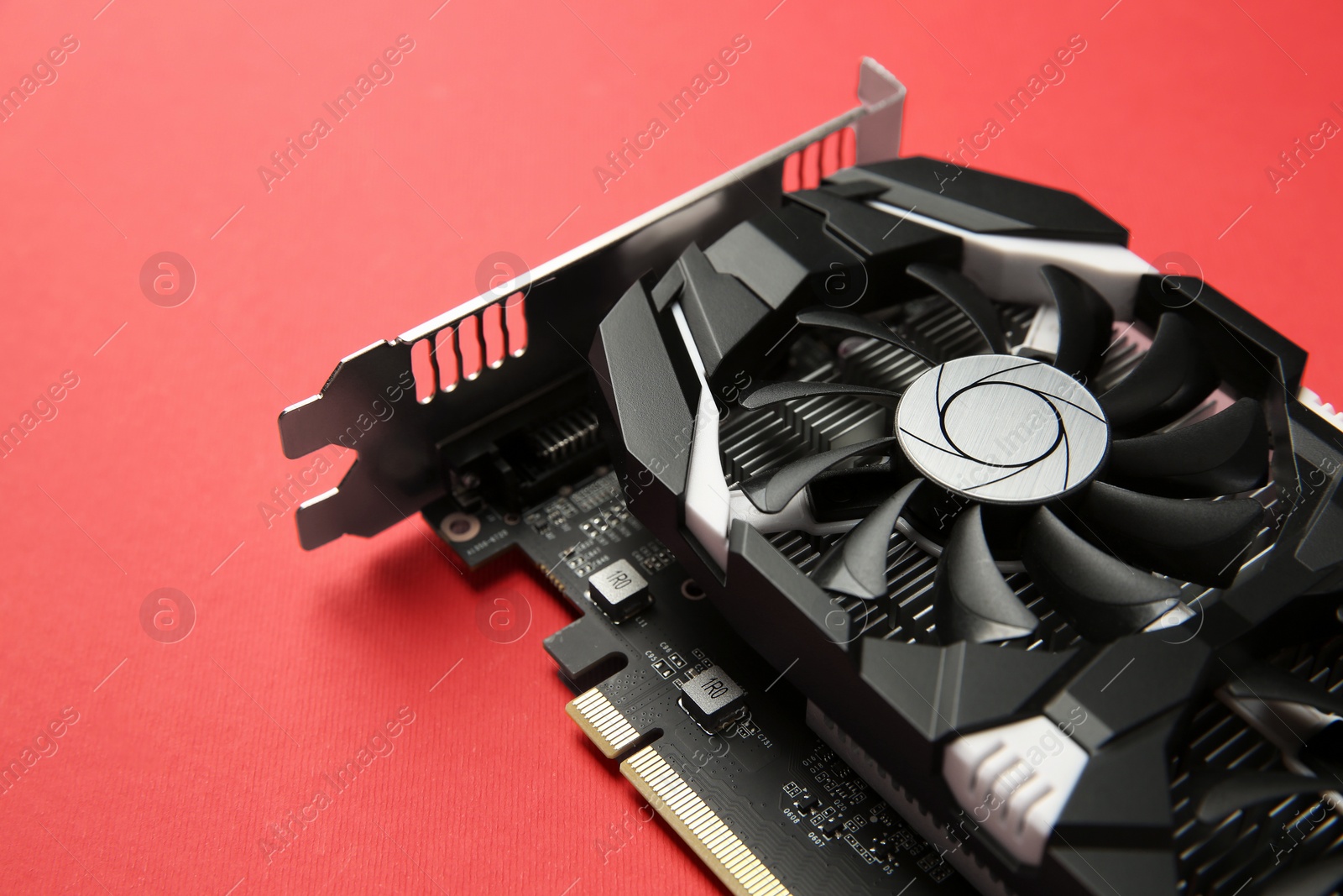 Photo of Computer graphics card on red background, closeup