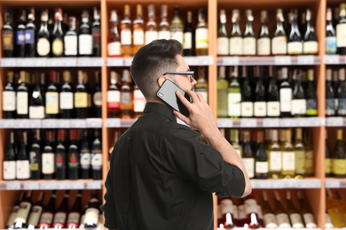 Image of Wholesale and logistics concept. Manager talking on phone in store
