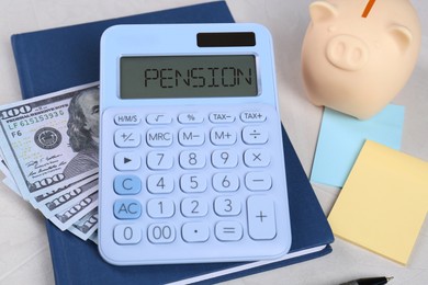 Photo of Calculator, dollar banknotes, piggy bank, notebook and sticky notes on light gray table. Retirement concept