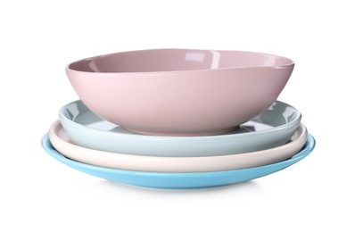 Photo of Stack of clean plates and bowl on white background