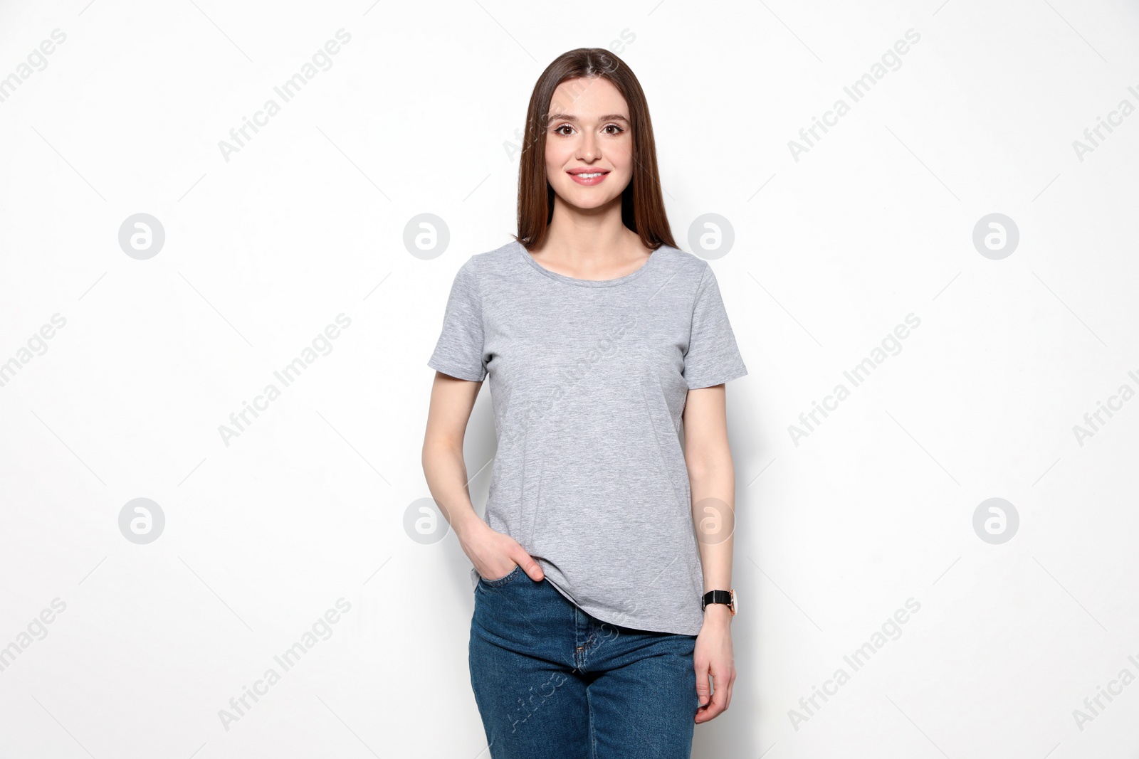 Photo of Young woman in t-shirt on light background. Mock up for design