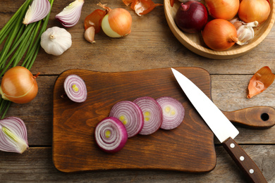 Photo of Flat lay composition with onion on wooden table