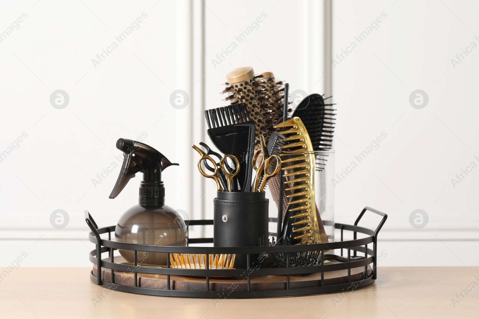 Photo of Set of hairdresser tools on table in salon