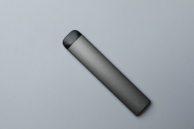 Photo of Electronic cigarette on light background, top view