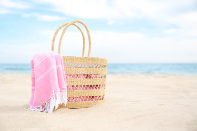 Photo of Different stylish beach objects on sand near sea. Space for text