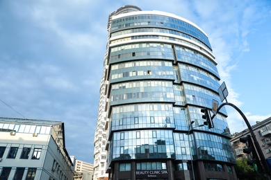 Photo of KYIV, UKRAINE - MAY 23, 2019: Modern office building against blue sky