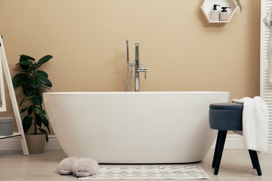 Photo of Cozy bathroom interior with stylish ceramic tub