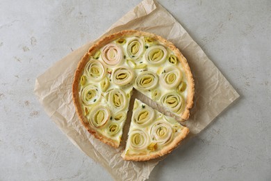 Photo of Tasty leek pie on grey textured table, top view