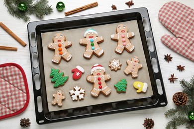 Photo of Delicious Christmas cookies and festive decor on white wooden table, flat lay