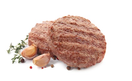 Photo of Tasty grilled hamburger patties with seasonings on white background
