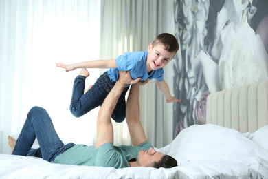 Photo of Dad and son having fun together at home. Happy Father's Day