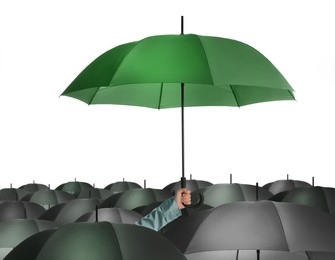 Person holding umbrella over other on white background 