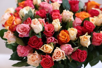 Photo of Bouquet of beautiful roses on light grey background, closeup