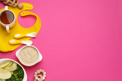 Photo of Silicone baby bib, toys and plastic dishware with healthy food on pink background, flat lay. Space for text