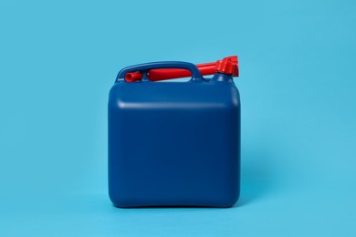 Photo of New plastic canister on light blue background