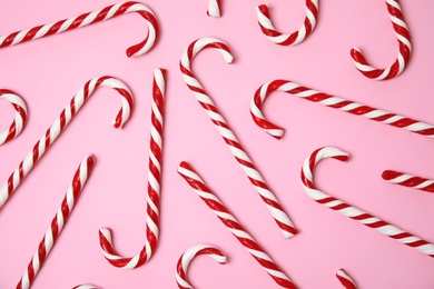 Photo of Flat lay composition with tasty candy canes on color background