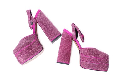 Photo of Fashionable punk square toe ankle strap pumps isolated on white, top view. Shiny party platform high heeled shoes