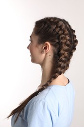 Photo of Woman with braided hair on light background