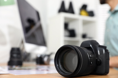 Photo of Photographer's workplace with professional camera in office