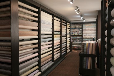 Photo of Assortment of stylish wall papers in shop
