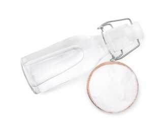 Photo of Vinegar in glass bottle and baking soda isolated on white, top view