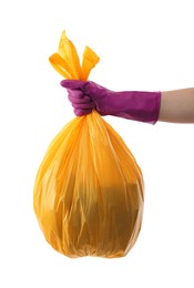 Photo of Woman holding plastic bag full of garbage on white background, closeup