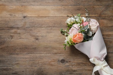 Photo of Bouquet of beautiful flowers on wooden table, top view. Space for text