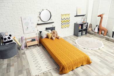 Photo of Montessori bedroom interior with floor bed and toys