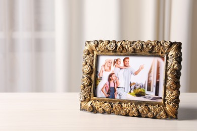 Photo of Vintage square frame with family photo on white table indoors, space for text