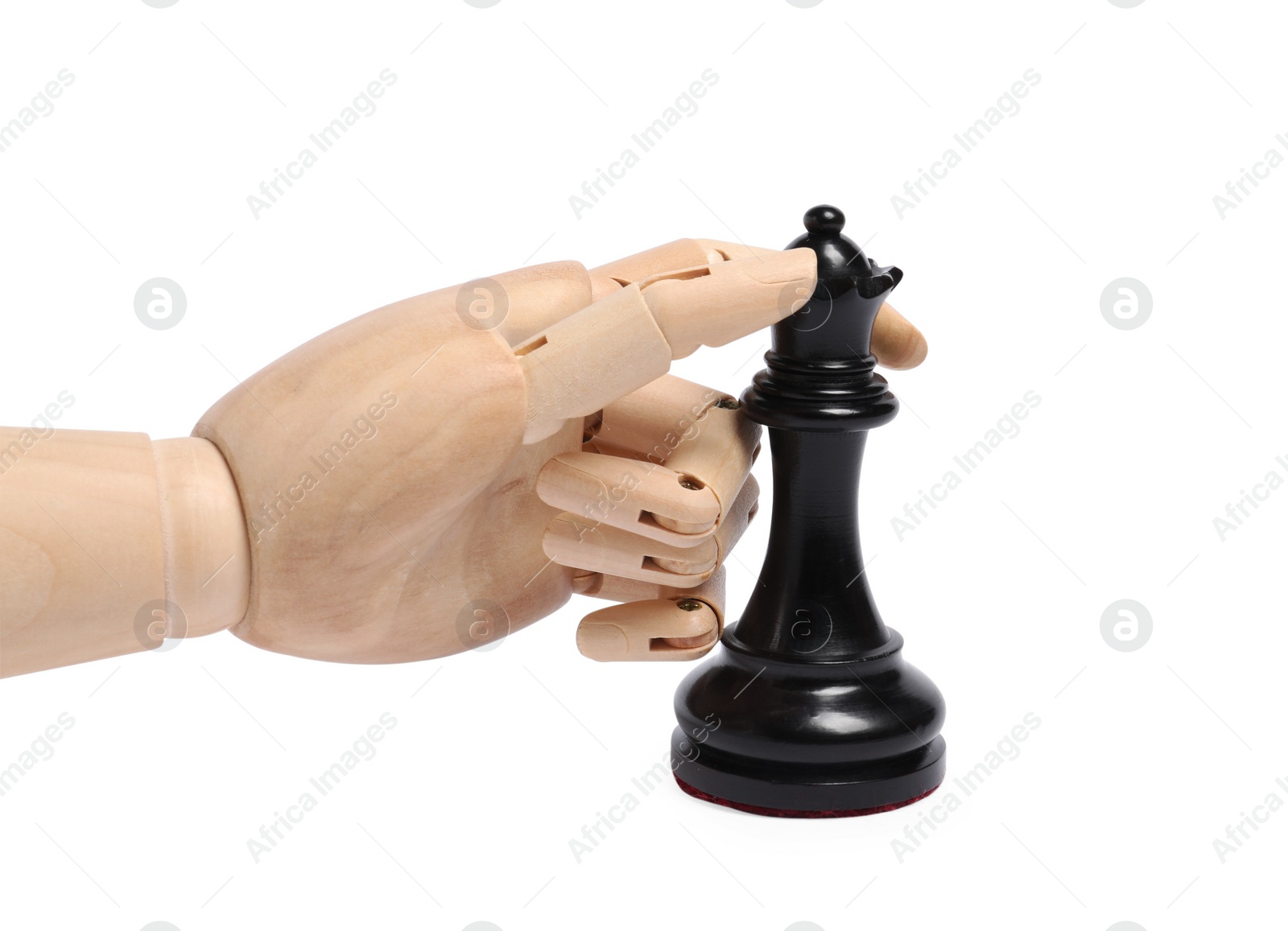 Photo of Robot with black chess piece isolated on white. Wooden hand representing artificial intelligence