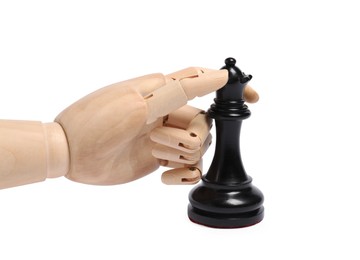 Photo of Robot with black chess piece isolated on white. Wooden hand representing artificial intelligence