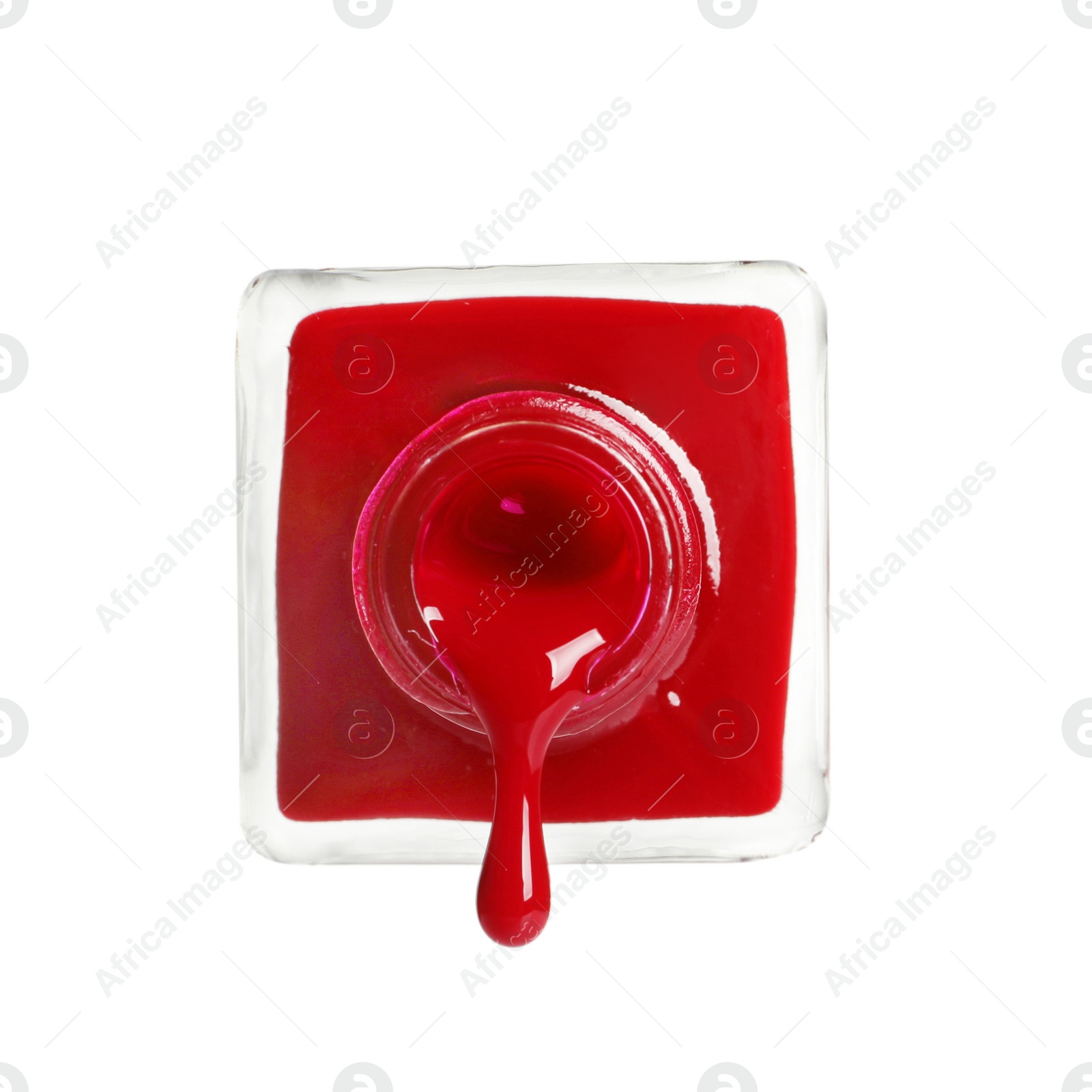 Photo of Pouring color nail polish from bottle on white background