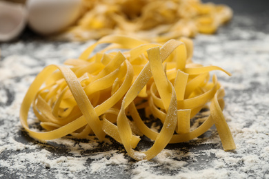 Photo of Tagliatelle pasta on grey table, closeup view